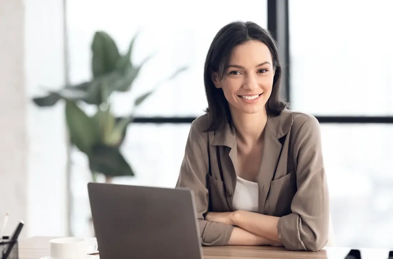 Woman sitting in front of a laptop in an office