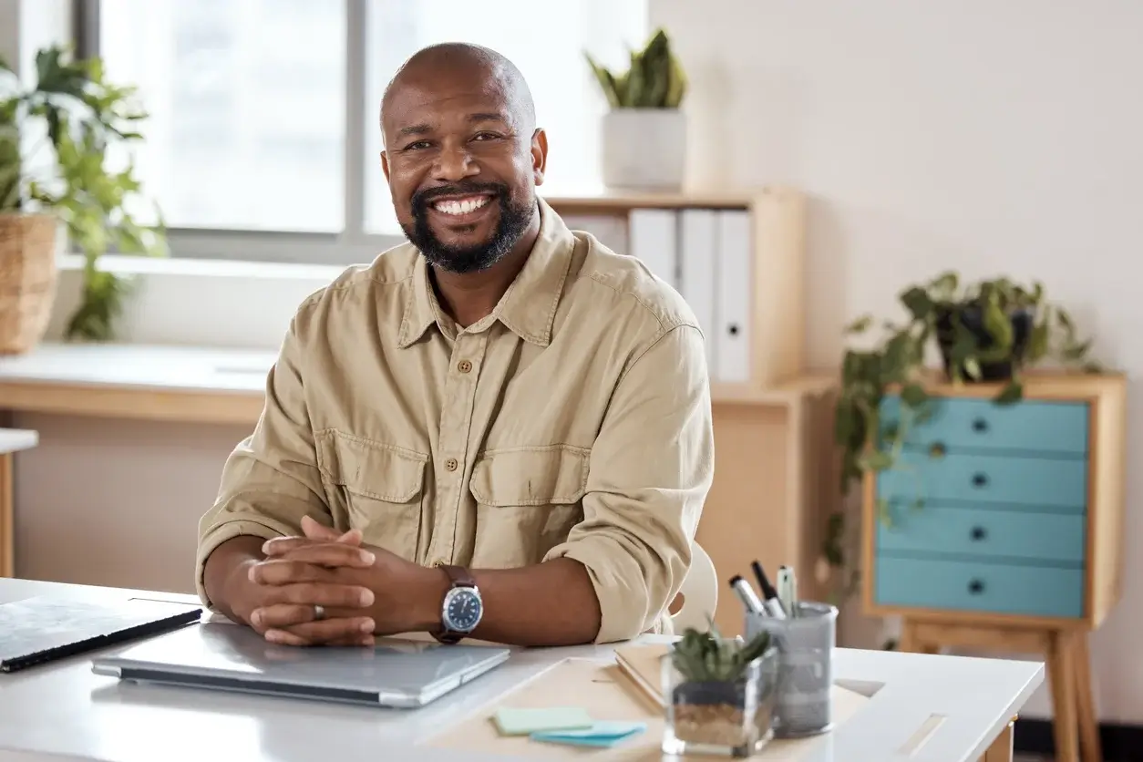 Man with his hands clasped in an office