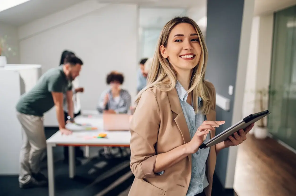 Woman in an office holding an ipad