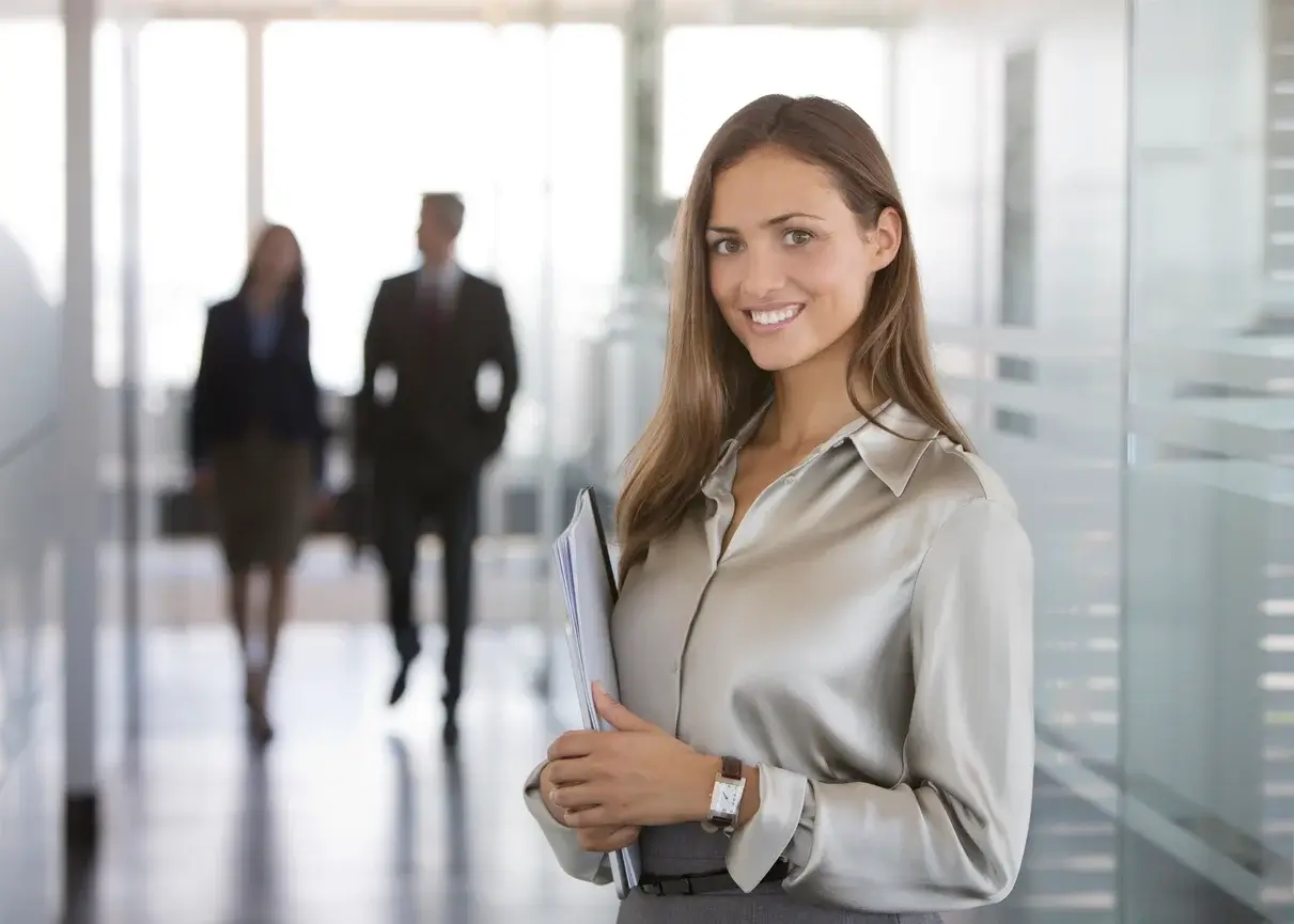 Woman in a green dress standing in an office