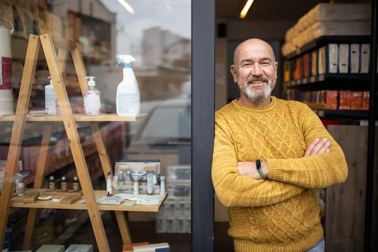 Man standing in the doorway of his shop