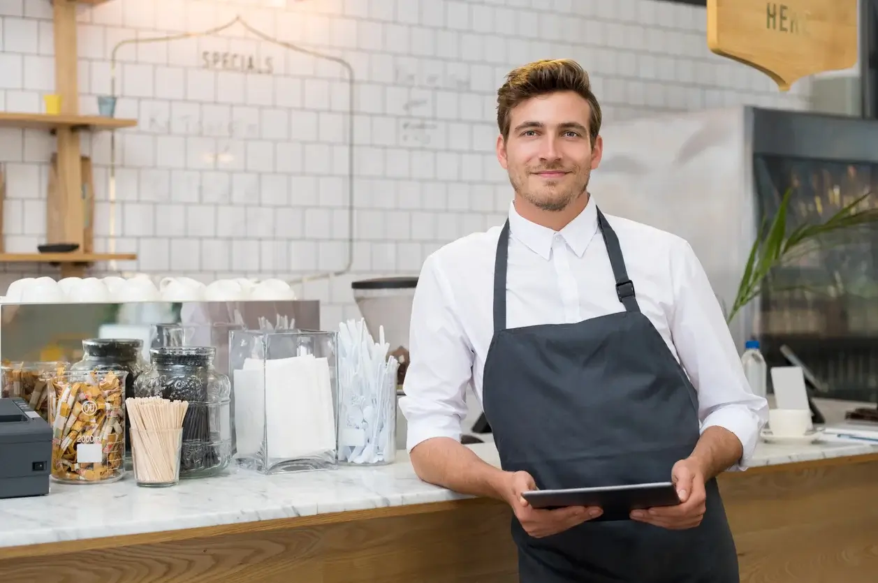 Coffee shop owner with an ipad in his hands